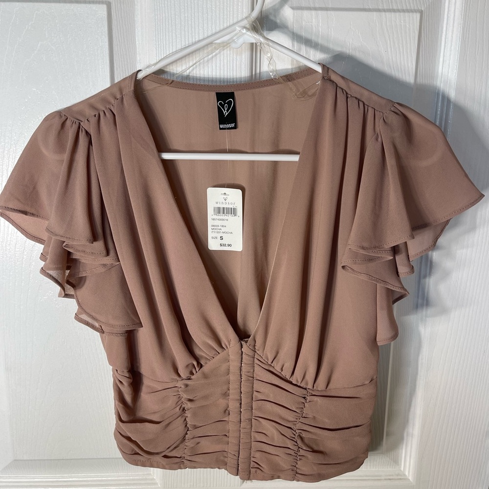 Crops shirt with low neck line and partial corset.